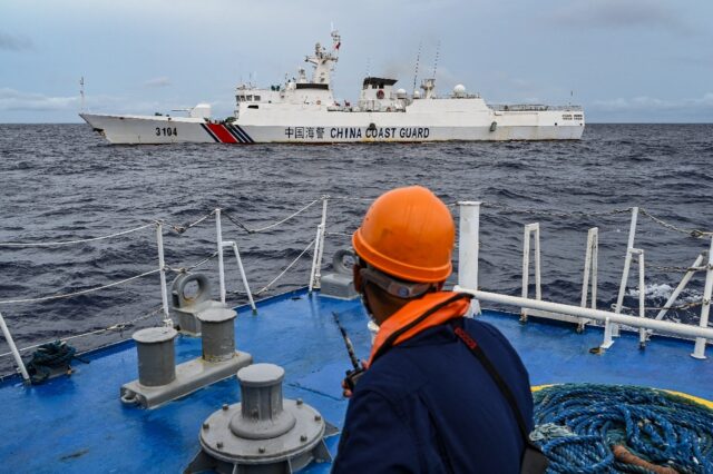 A China Coast Guard ship is seen from a Philippine Coast Guard vessel during a supply miss