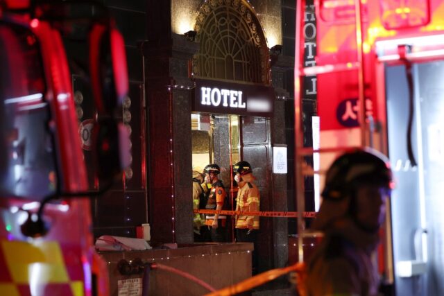 Firefighters enter a hotel in Bucheon where a fire broke out Thursday evening