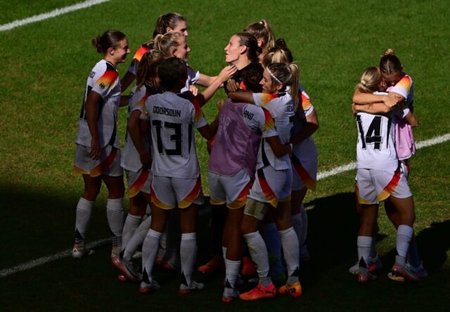 Germany goalkeeper Ann-Katrin Berger is surrounded by teammates after her dramatic last-ga