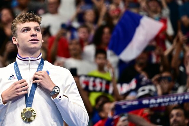 Gold medallist France's Leon Marchand poses with his medal