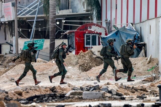 Israeli soldiers take position during an army operation in Tulkarem in the north of the oc