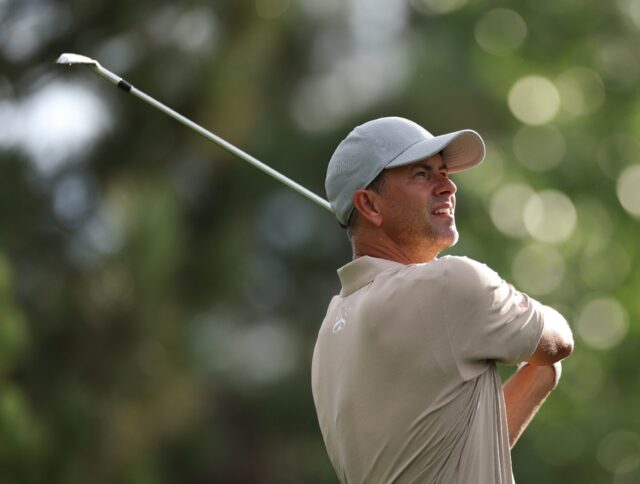 Leader Adam Scott of Australia watches his tee shot on the 4th hole during the second roun