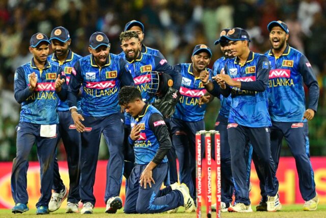 Leg-spinner Sri Lanka's Jeffrey Vandersay (kneeling) celebrates as he takes a career best