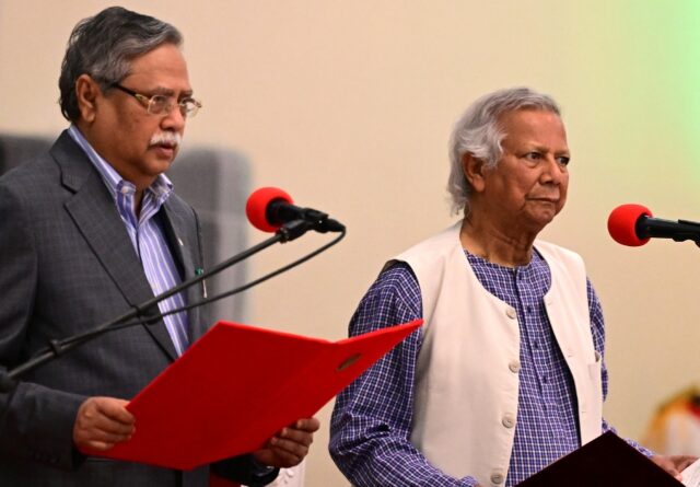 Nobel Peace Prize winner Muhammad Yunus (R) takes the oath of office to lead Bangladesh's