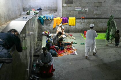 Patients queue in a subway near a hospital waiting to see a doctor in New Delhi amid a doc