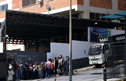 Relatives of people detained in post-election protests wait for news outside a jail in Car