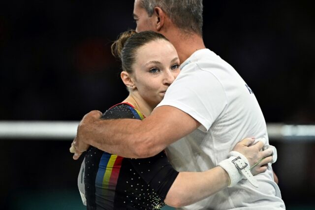 Romanian gymnast Ana Barbosu with her coach during the Paris Olympics