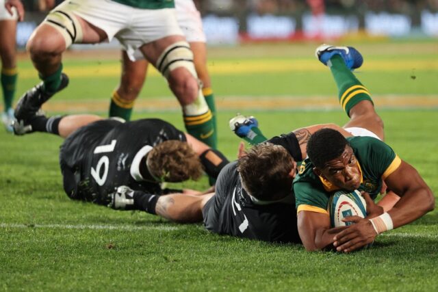 South Africa scrum-half Grant Williams (R) score the winning try against the All Blacks at