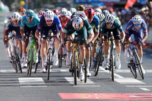 Team Visma's Wout van Aert (C) sprints to cross the finish in first place in Vuelta stage