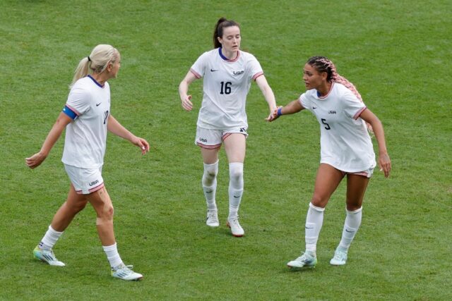 Trinity Rodman (R) celebrates with teammates after scoring for the United States against J