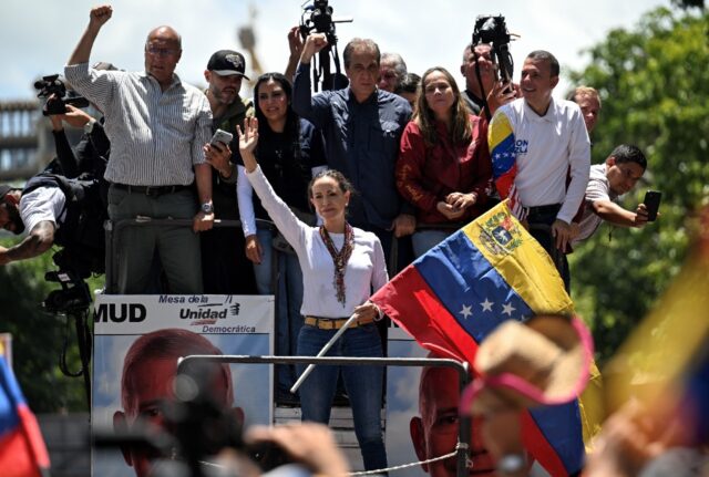 Venezuelan opposition leader Maria Corina Machado waves during a demonstration against pre