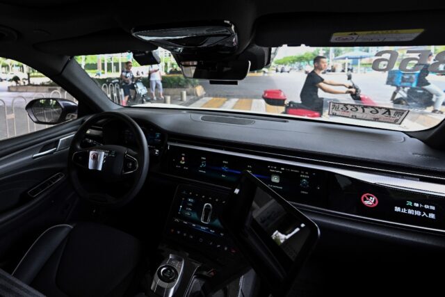 A view from the back seat of a driverless taxi as it navigates through Wuhan, now home to