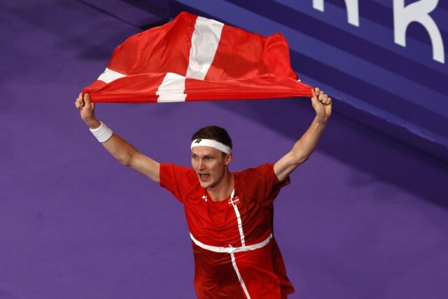 Viktor Axelsen celebrates with a Danish national flag