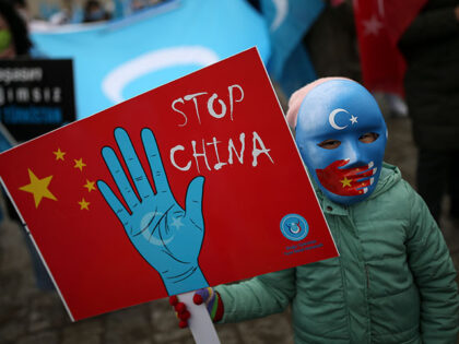 A protester from the Uyghur community living in Turkey, holds an anti-China placard during