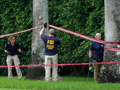 Law enforcement officials work at the scene of the Trump International Golf Club in the af