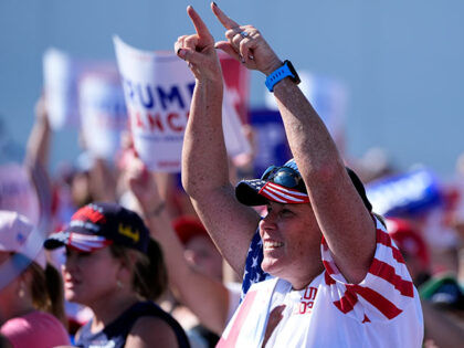 A supporter gestures as Republican presidential nominee former President Donald Trump spea