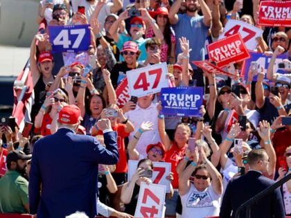 Supporters cheer Republican presidential nominee former President Donald Trump as he arriv