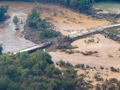 An aerial view a damaged bridge and flooding in the aftermath of Hurricane Helene is seen