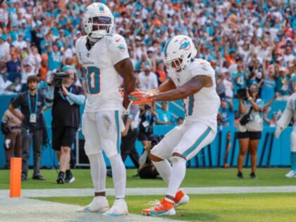 Miami Dolphins wide receiver Tyreek Hill (10) holds his hands behind his back as if he is