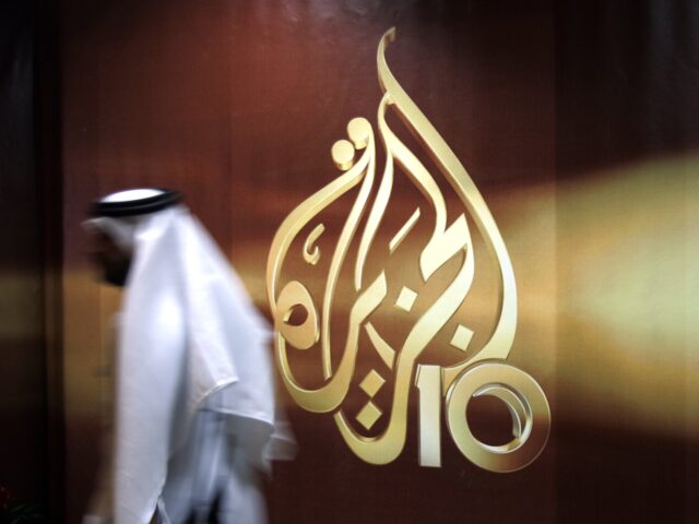 FILE - In this Wednesday Nov. 1, 2006 file photo, A Qatari employee of Al Jazeera Arabic l