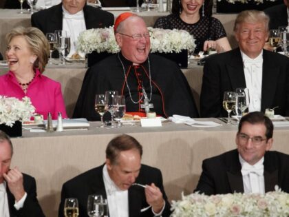 Republican presidential candidate Donald Trump, right, laughs at a joke with Cardinal Timo