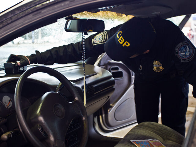 CBP Officer Inspects Vehicle for Drugs (U.S. Customs and Border Protection)