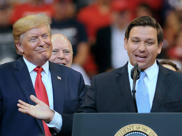 U.S. President Donald Trump looks on as Florida Governor Ron...