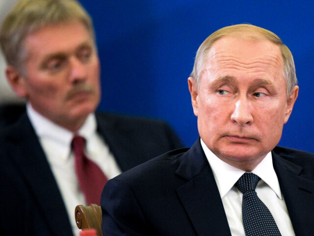 Russian President Vladimir Putin, right, and Kremlin spokesman Dmitry Peskov, attend the E