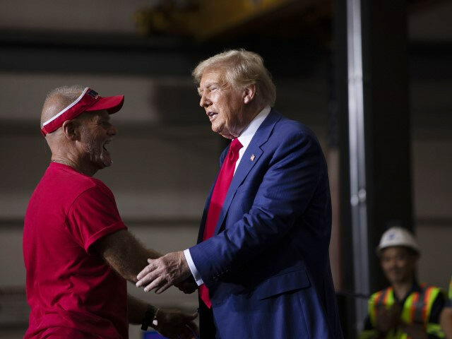 Republican presidential nominee, former U.S. President Donald Trump brings an auto worker