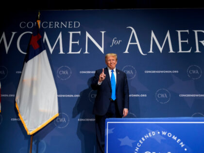 Former President Donald Trump stands on stage before speaking at a Concerned Women for Ame