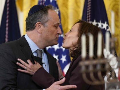 FILE - Vice President Kamala Harris and second gentleman Doug Emhoff kiss during an event