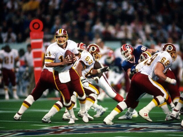 MINNEAPOLIS, MN - JANUARY 26: Mark Rypien #11 of the Washington Redskins turns to hand th