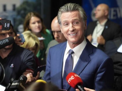 California Gov. Gavin Newsom speaks to reporters in the spin room before a presidential de