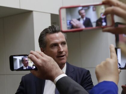 Democratic candidate Gavin Newsom speaks with reporters after a California gubernatorial d