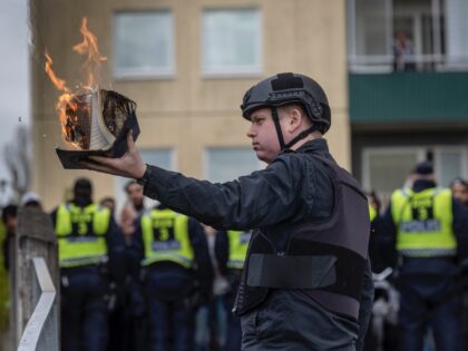 STOCKHOLM, SWEDEN - MAY 14: Rasmus Paludan burns a Koran during an election meeting in Hus