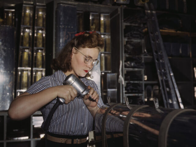 Operating a hand drill at the North American Aviation, Inc., [a] woman is in the control s