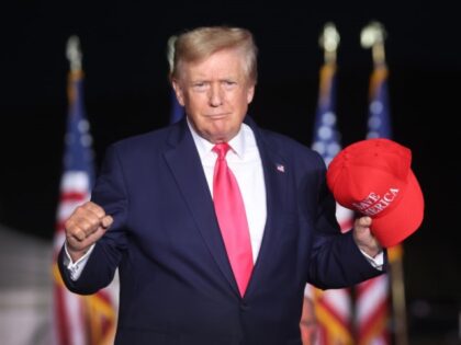 Former President Donald Trump greets supporters during a rally on August 05, 2022 in Wauke