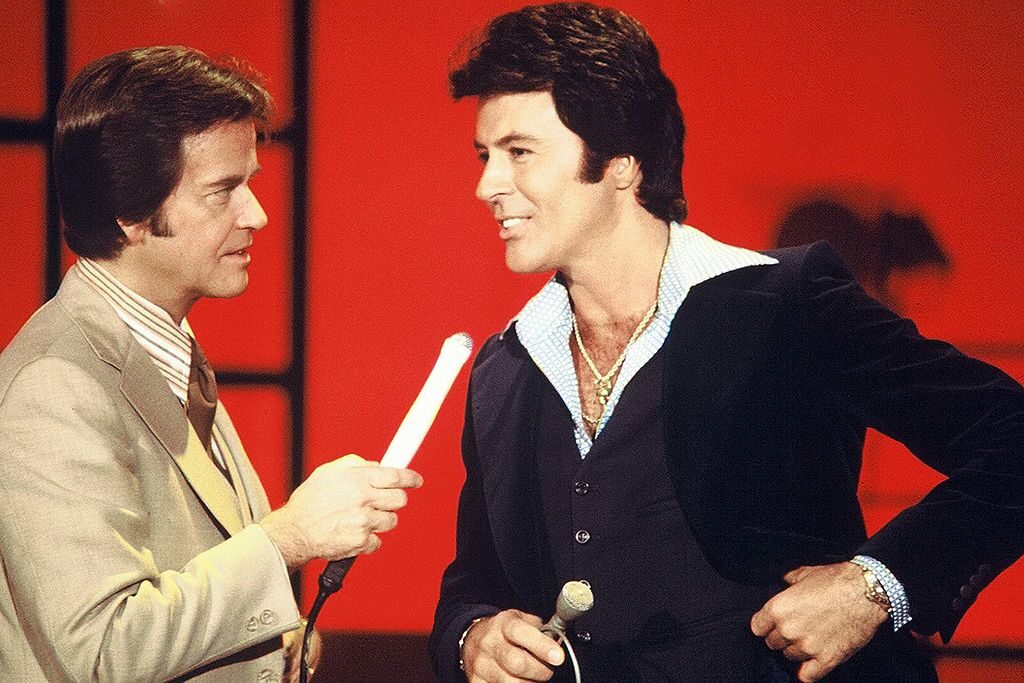 AMERICAN BANDSTAND - 4/16/1977 Singer and actor James Darren (right) is interviewed by host Dick Clark on American Bandstand. (Photo by ABC Photo Archives/Disney General Entertainment Content via Getty Images)