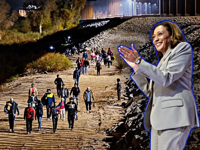 YUMA, ARIZONA - DECEMBER 30: Immigrants walk along the U.S.-Mexico border barrier on their