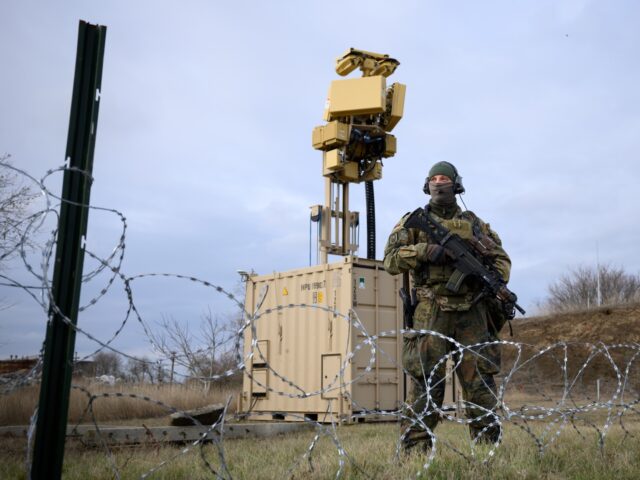 05 December 2023, Romania, Constanta: A Bundeswehr soldier stands in front of a defense sy