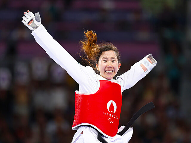 Zakia Khudadadi of Refugee Paralympic Team celebrates after winning the Women's Taekw