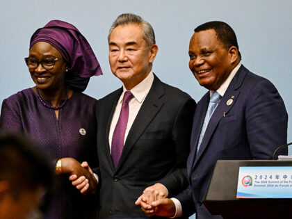 China's foreign minister Wang Yi (C) shakes hands with his counterparts, Senegal's Yassine