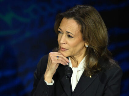 US Vice President and Democratic presidential candidate Kamala Harris listens to former US