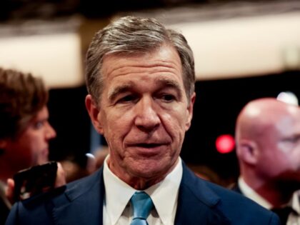 Roy Cooper, governor of North Carolina, speaks to members of the media in the spin room fo