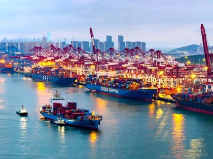 Container ships load and unload at a berth at the Qianwan Container Terminal of Qingdao Po