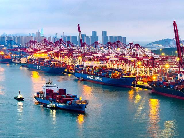 Container ships load and unload at a berth at the Qianwan Container Terminal of Qingdao Po