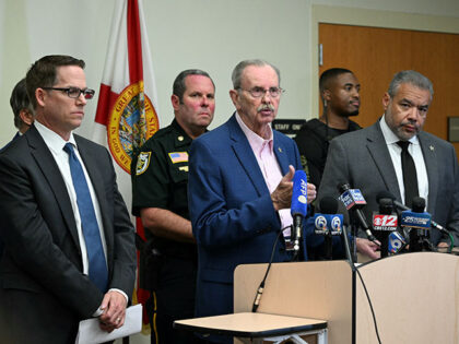 Palm Beach County Sherrif Ric Bradshaw (C) speaks alongside Jeffrey Veltri (L), special ag