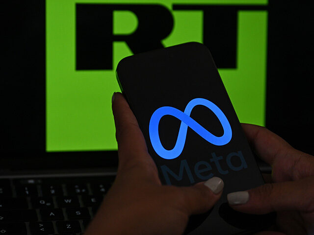 In this photo illustration, the 'Meta' logo is displayed on a mobile phone screen in front