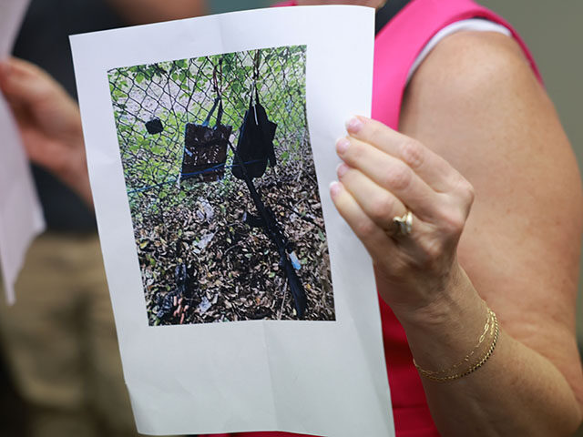 Palm Beach County Sheriff PIO Teri Barber holds a photograph of the rifle and other items