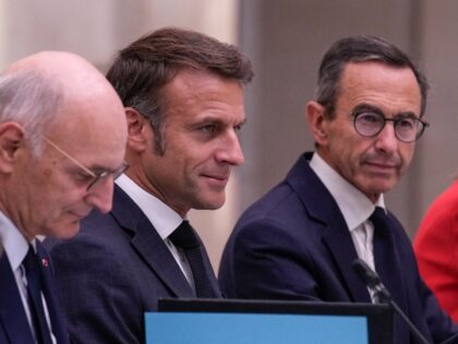 French President Emmanuel Macron (C) is flanked by newly appointed French Minister of Just